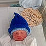 Teddie joined the competition — help win amazing prizes! newborn, baby, sleeping, blue_hat, white_onesie, hospital_bassinet, blanket, birth_announcement, sign, soft_fabric, infant, peaceful, cute, portrait, child, hospital, crib, knit_hat, resting, young_baby