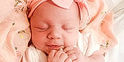 Maisie is registered to the contest to win money with this photo: baby, sleeping, infant, pink, headband, bow, blanket, floral, soft, cozy, cute, peaceful, newborn, white_clothing, hands, portrait, closeup, indoors, child, adorable