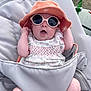 baby, infant, sunglasses, hat, baby_seat, outdoor, clothing, sun_hat, pink, white, patterned_dress, expression, cute, child, summer, shade, accessory, relaxing, person, seat