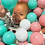 Liam is registered to the contest to win money with this photo: baby, child, balls, ball_pit, playing, smiling, happy, pastel_colors, indoor, toy, fun, cute, face, hand, clothing, mickey_mouse, colorful, plastic, young, person