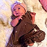 Lillie joined the competition — help win amazing prizes! baby, blanket, brown_dress, child, cozy, cute, expression, face, hand, headband, indoor, infant, lying_down, newborn, pink, shell_decoration, small_hands, sock, soft_texture, white