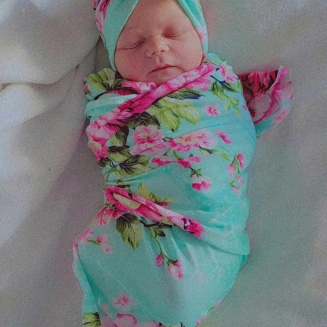 Kalena joined the competition — help win amazing prizes! newborn, baby, sleeping, swaddled, infant, portrait, floral, headband, bow, blanket, pink, turquoise, indoors, bed, soft, peaceful, face, closed_eyes, textile, photography