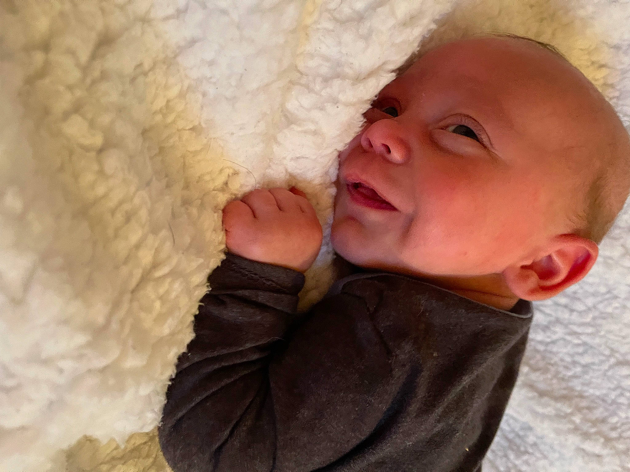 Jasper is registered to the contest to win money with this photo: baby, baby_toddler_clothing, cheek, child, comfort, finger, fun, fur, gesture, happy, linens, lip, nail, nose, person, skin, sleeve, smile, textile, thumb