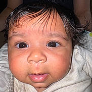 Ocean is registered to the contest to win money with this photo: baby, close_up, face, wet_hair, curious, child, infant, person, portrait, eyes, skin, clothing, fabric, calvin_klein, background, indoor, young_child, cute, expression, head