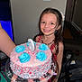 child, girl, birthday_cake, cake, candle, smile, party, celebration, colorful, sprinkles, frosting, long_hair, necklace, red_dress, indoor, home, happy, holding, nail_polish, person