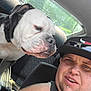 Tank is registered to the contest to win money with this photo: man, dog, car, selfie, cap, pet, window, seat, interior, daylight, casual, portrait, animal, closeup, outdoor, smile, beard, black_clothing, collar, seatbelt