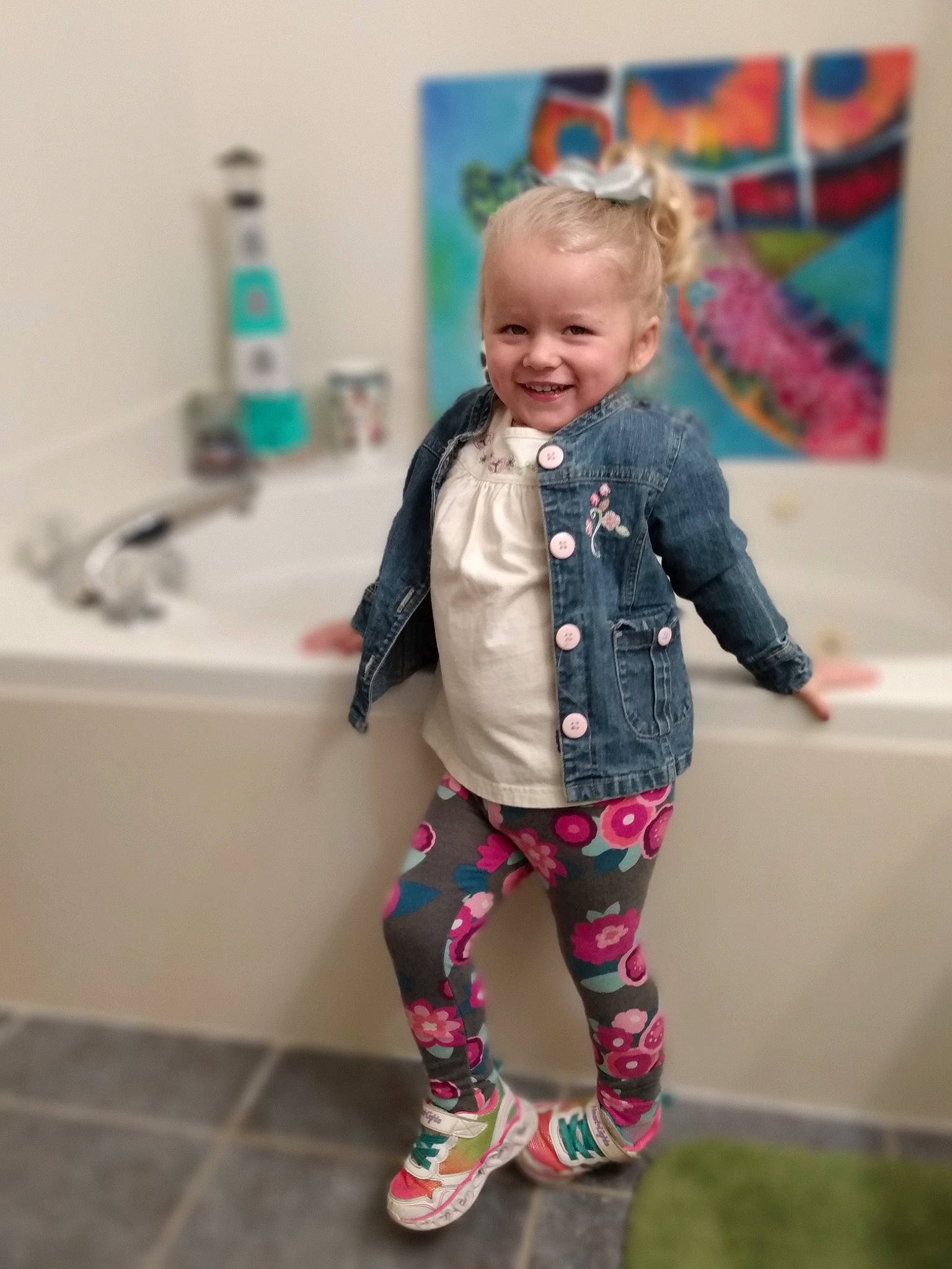 Lydia joined the competition — help win amazing prizes! baby, baby_toddler_clothing, bathroom, blond, child, flooring, fun, happy, head, joy, outerwear, person, pink, plumbing, plumbing_fixture, product, purple, sleeve, smile, standing
