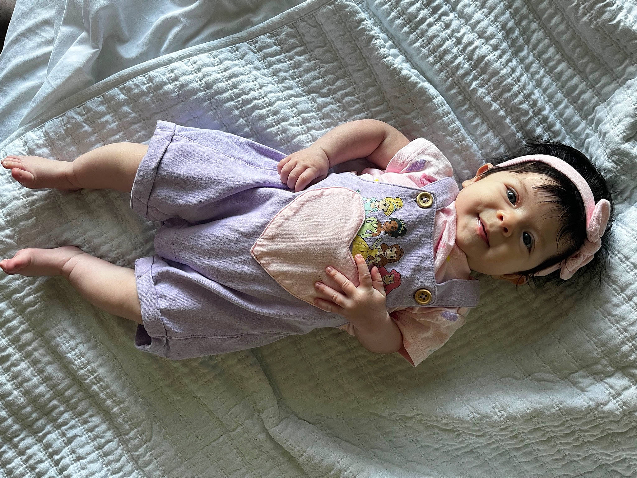 Brielle is registered to the contest to win money with this photo: baby, baby_toddler_clothing, child, comfort, eye, flash_photography, grass, happy, head, human_leg, joint, leg, leisure, linens, nap, person, sitting, skin, thigh, toddler