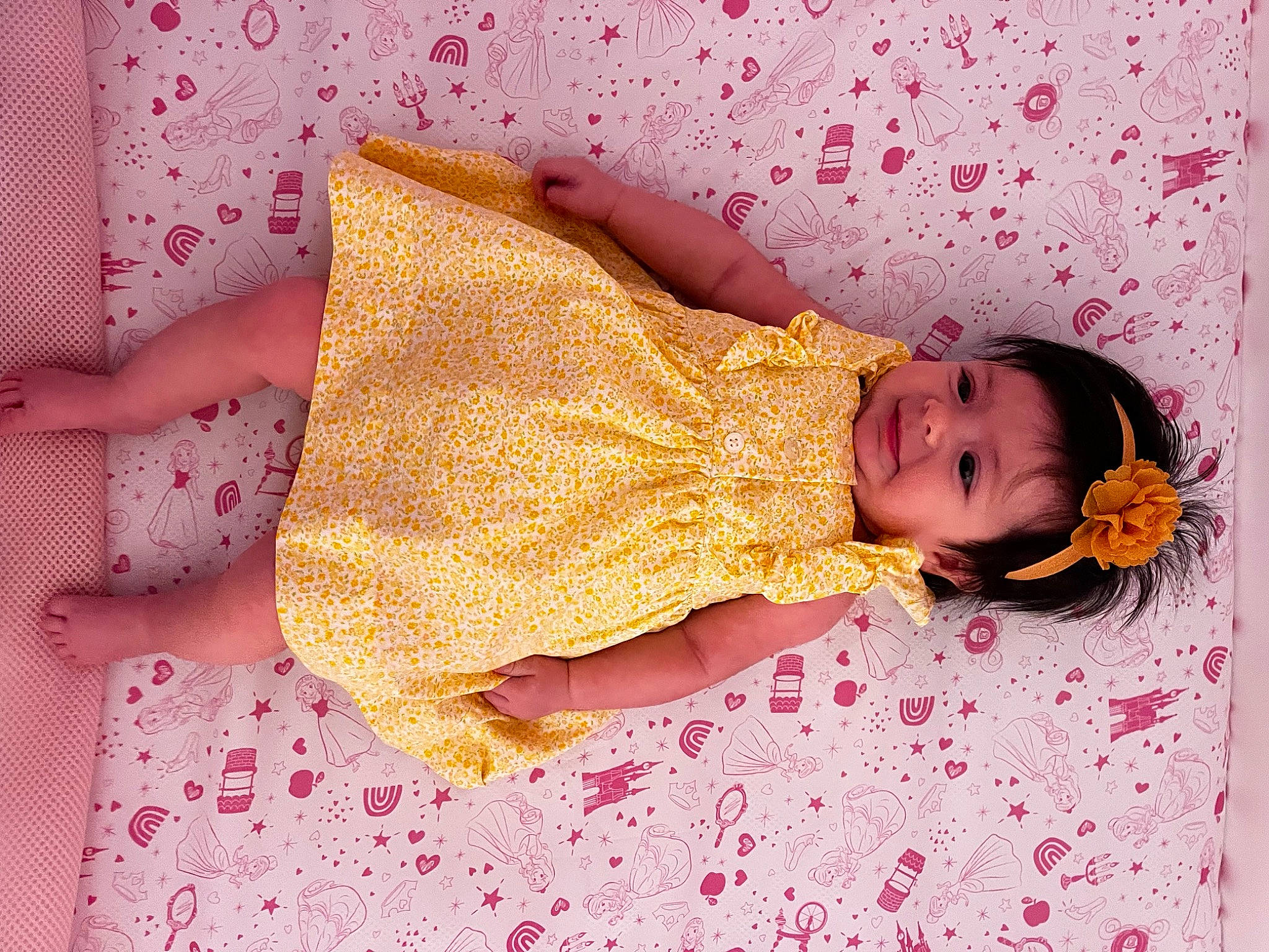 Brielle joined the competition — help win amazing prizes! arm, baby, baby_toddler_clothing, cheek, child, comfort, dress, flooring, hand, human_body, joy, leg, linens, magenta, orange, pattern, person, pink, skin, sleeve