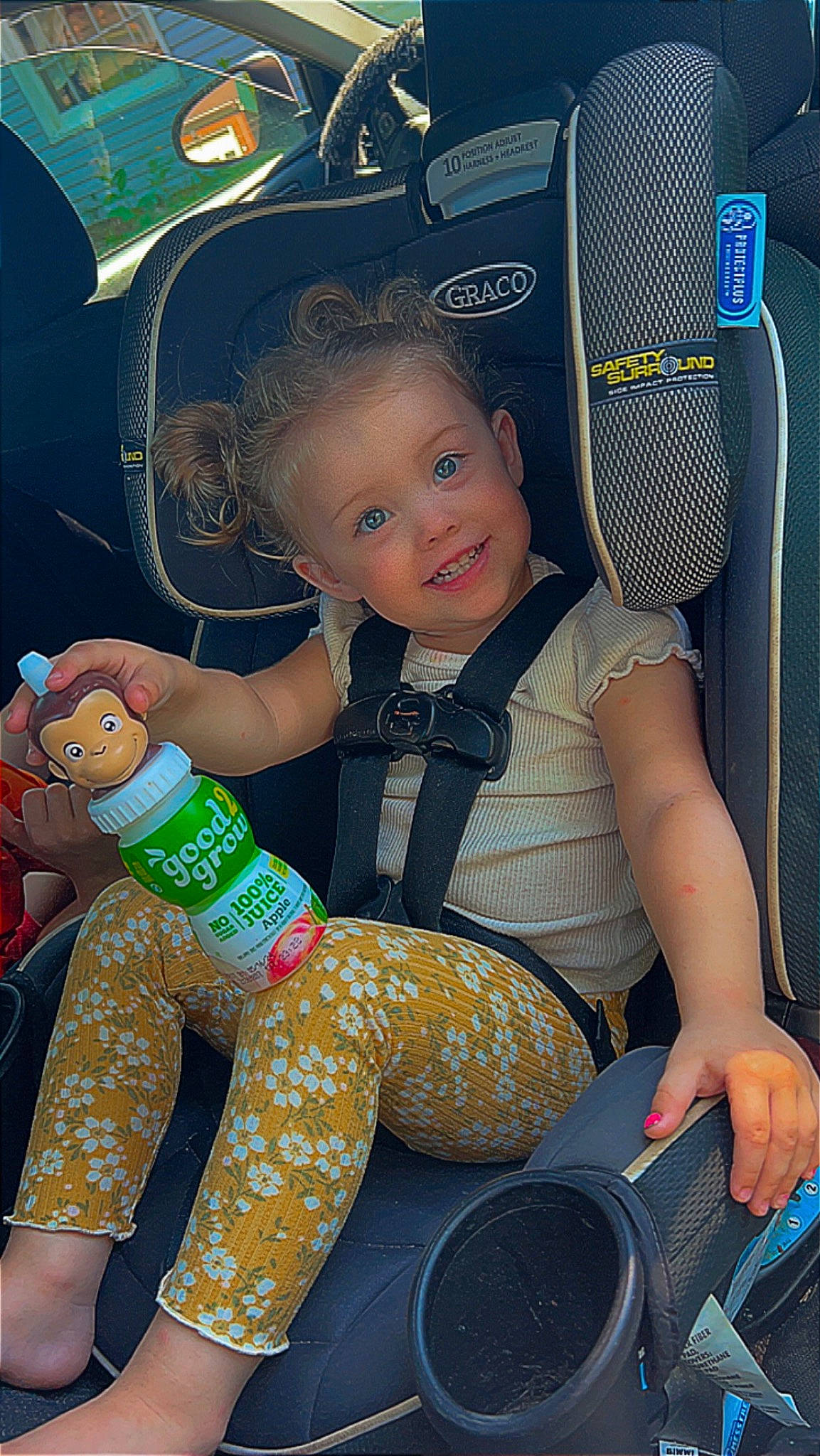 Maizy is registered to the contest to win money with this photo: baby_products, baby_toddler_clothing, car_seat, chair, child, cool, electric_blue, finger, fun, happy, human_leg, knee, lap, person, product, sitting, smile, thigh, thumb, toddler