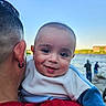 Elvis is registered to the contest to win money with this photo: baby, child, person, adult, earring, face, smile, outdoor, river, water, fishing, sky, hairstyle, clothing, holding, portrait, daylight, happy, cute, nature