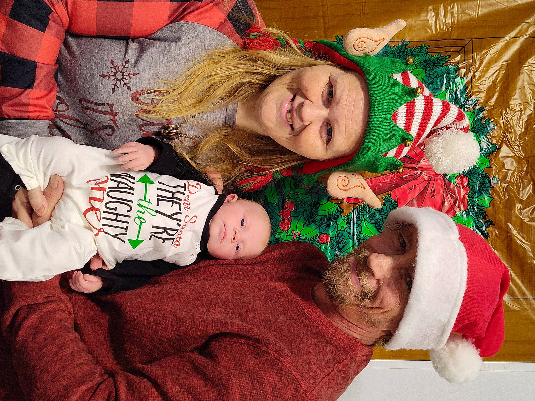 Jolie is registered to the contest to win money with this photo: baby, baby_toddler_clothing, child, christmas, christmas_eve, christmas_tree, comfort, event, facial_expression, fictional_character, fun, happy, headwear, holiday, human_body, joy, lap, person, playing_with_kids, smile