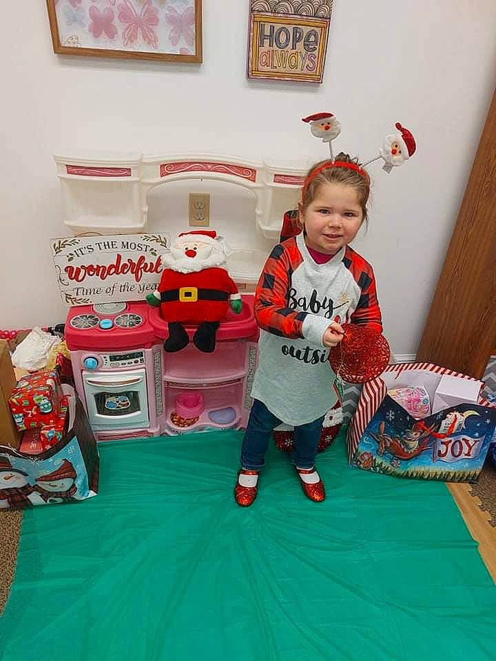 Jolene is registered to the contest to win money with this photo: baby_toddler_clothing, bag, child, event, fashion, flooring, fun, holiday, joy, linens, living_room, orange, pattern, person, picture_frame, play, product, room, t_shirt, textile