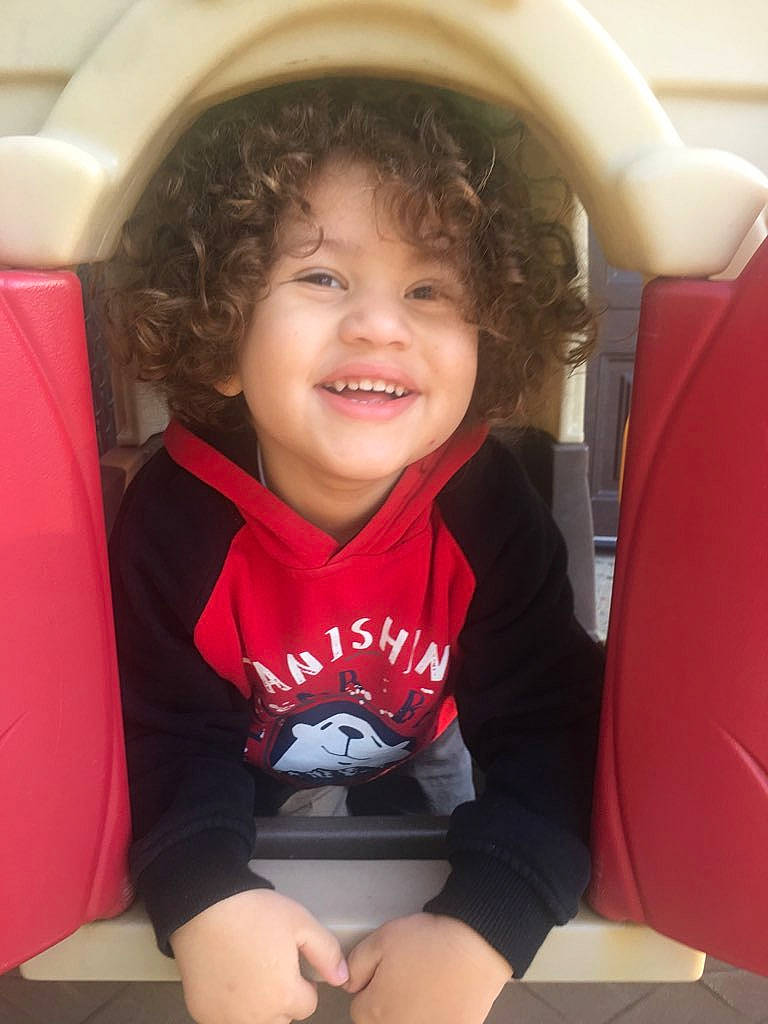 Zayden is registered to the contest to win money with this photo: cheek, child, cool, day, facial_expression, fun, girl, joy, leg, person, product, red, sitting, skin, smile, t_shirt, toddler, tooth