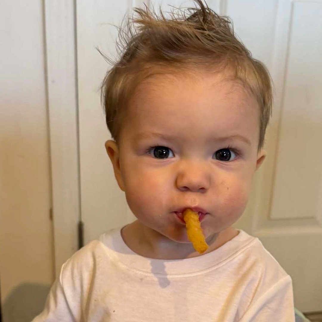 Grayson is registered to the contest to win money with this photo: baby, biting, bodypart, clothing, cream, dessert, door, eating, face, finger, food, hand, head, icecream, lunch, meal, person, photography, portrait, t_shirt