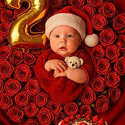 Emely is registered to the contest to win money with this photo: baby, santa_hat, red_outfit, teddy_bear, roses, heart_shape, gold_balloon, number_2, birthday_cake, strawberries, cake, celebration, festive, cute, portrait, infant, holiday_theme, red_background, smiling, child