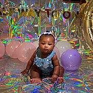 Clover joined the competition — help win amazing prizes! baby, balloons, denim_overalls, hair_bows, birthday, celebration, holographic_background, gold_letters, pastel_colors, floor, indoor, child, portrait, cute, sitting, colorful, milestone, party, decorations, infant