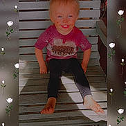 Raelynn is registered to the contest to win money with this photo: toddler, child, smiling, barefoot, messy_face, wooden_bench, sitting, pink_shirt, black_pants, outdoor, sunlight, portrait, happy, young_child, cute, face, legs, feet, flower_border, casual
