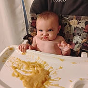 Everly joined the competition — help win amazing prizes! baby, high_chair, messy, food, baby_food, expression, face, mess, feeding, infant, cute, chubby_cheeks, hand, tray, indoor, curtain, cosco, determined, grumpy, sitting