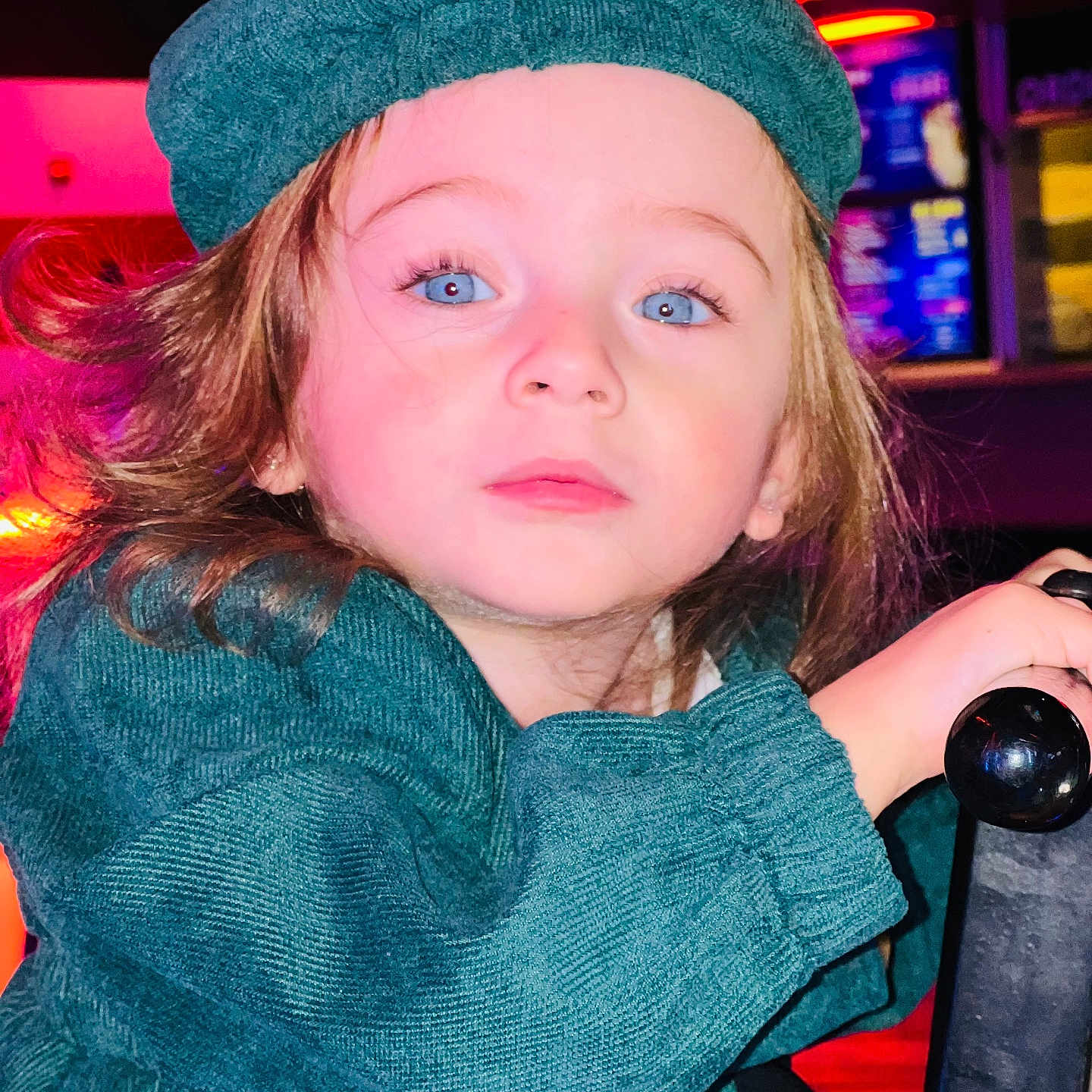 Seleen is registered to the contest to win money with this photo: baby, blonde, bodypart, cap, clothing, coat, face, finger, hair, hand, hat, head, jacket, nightlife, person, photography, portrait, pub, purple, urban