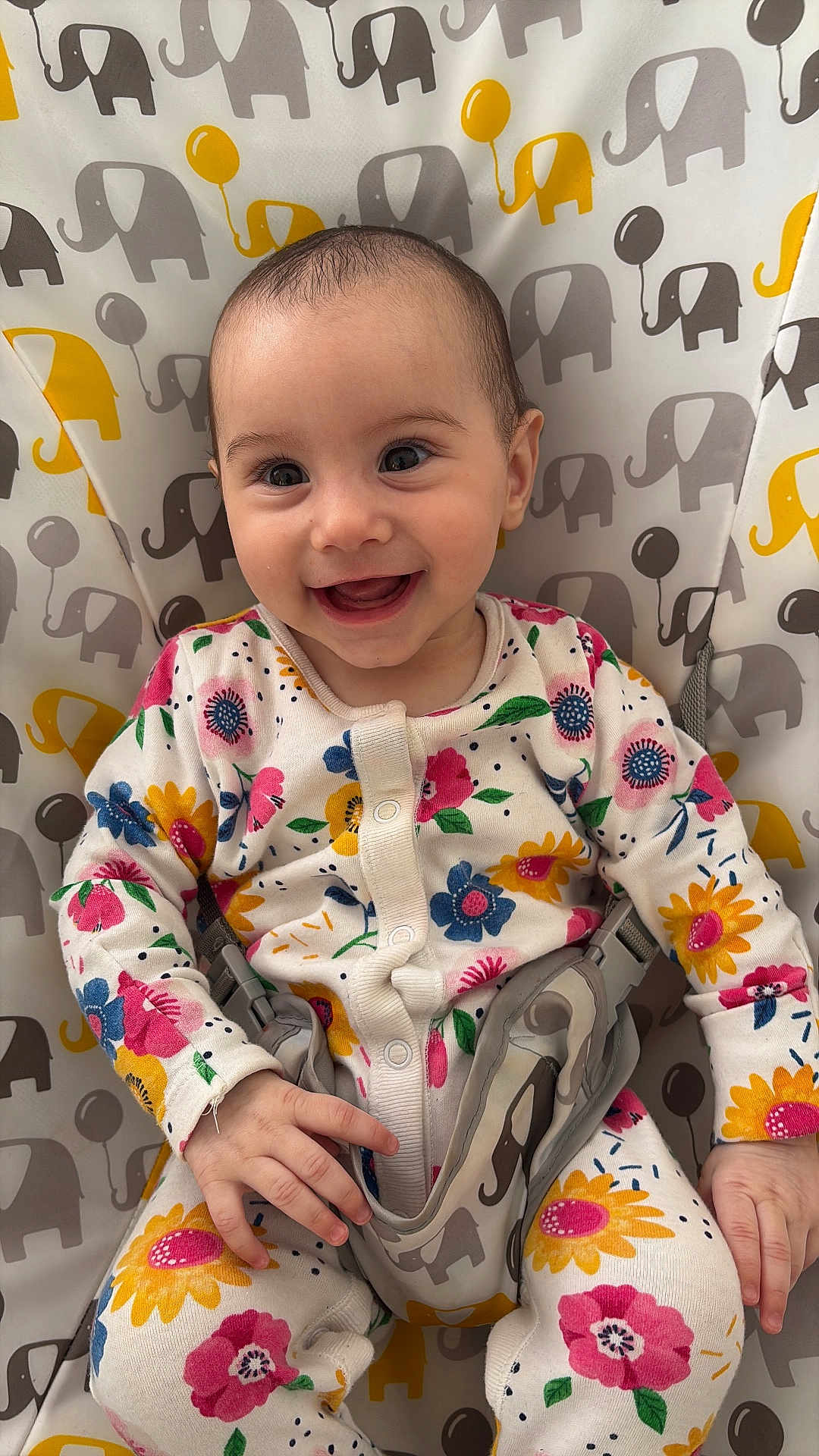 Hîvda Róisín joined the competition — help win amazing prizes! baby, smiling, infant, floral_clothing, onesie, baby_seat, elephant_pattern, happy, child, cute, face, hands, sitting, indoor, colorful, patterned_fabric, young, portrait, baby_girl, joyful