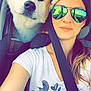 animal, bird_design, car, casual, closeup, companion, daylight, dog, friendly, hair, interior, pet, portrait, reflection, seatbelt, selfie, smile, sunglasses, white_shirt, woman