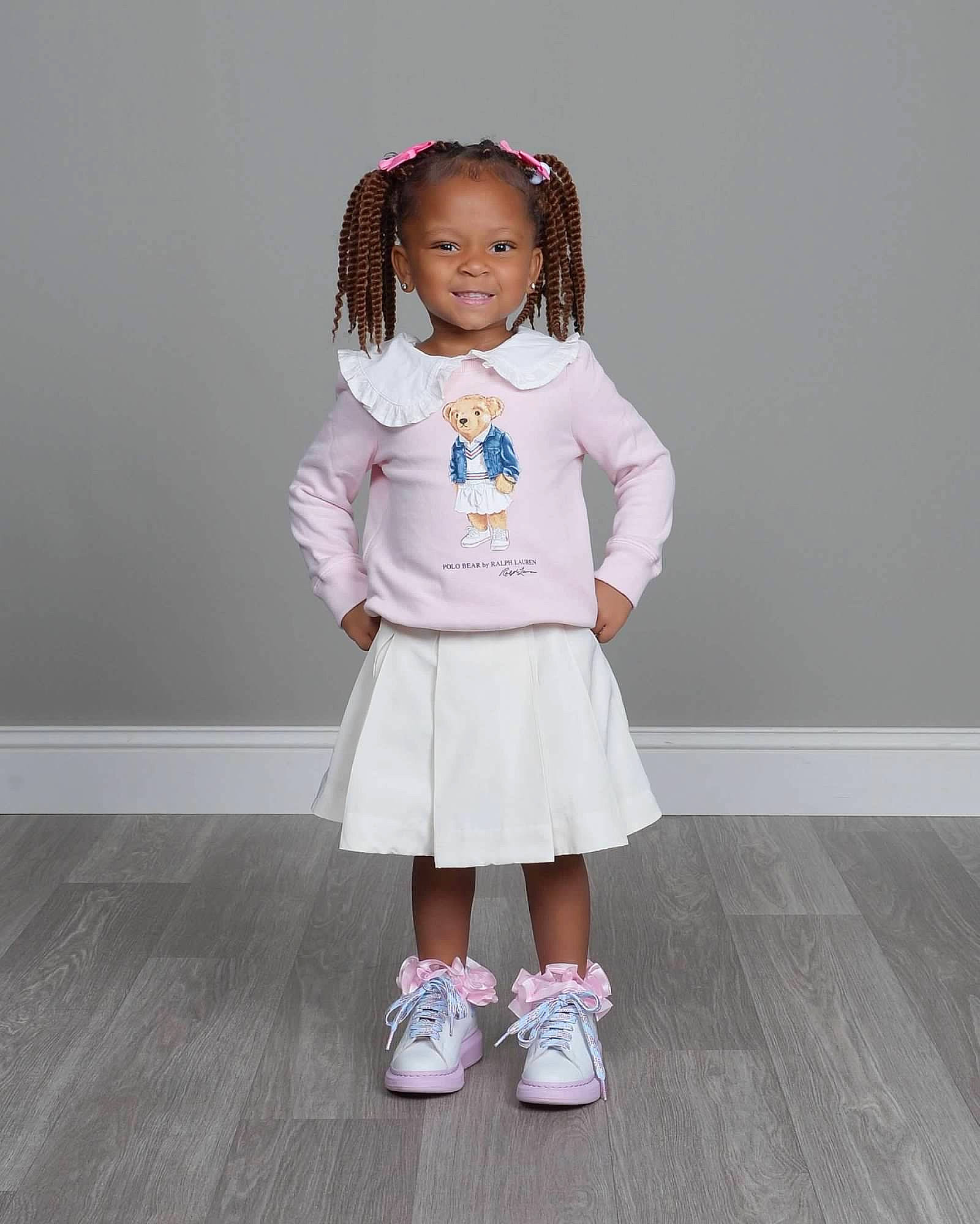 Amira joined the competition — help win amazing prizes! costume, fashion_accessory, fashion_design, formal_wear, happy, human_body, human_leg, joy, knee, pattern, person, school_uniform, shoulder, skin, sleeve, smile, sock, t_shirt, thigh, toddler