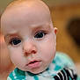 Liam joined the competition — help win amazing prizes! baby, close_up, face, eyes, infant, child, young, curious, expression, skin, head, portrait, person, apparel, shirt, soft_focus, indoors, cute, small, human