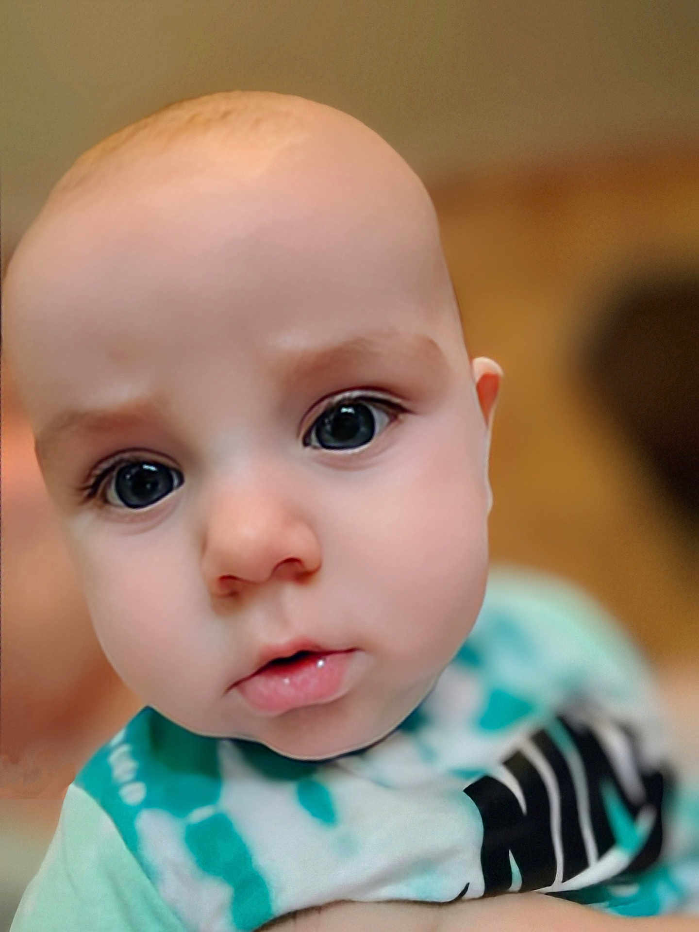 Liam joined the competition — help win amazing prizes! baby, close_up, face, eyes, infant, child, young, curious, expression, skin, head, portrait, person, apparel, shirt, soft_focus, indoors, cute, small, human