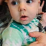 Liam joined the competition — help win amazing prizes! baby, child, face, blue_eyes, curious, tie_dye_shirt, hand, holding, close_up, infant, skin, person, expression, indoor, soft_light, young, portrait, cute, chubby_cheeks, baby_clothes