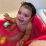 baby, bathtub, child, bath, water, smile, happy, hand, toy, curl_hair, skin, playful, pink, bathroom, sitting, wet, cute, infant, holding_hand, expression