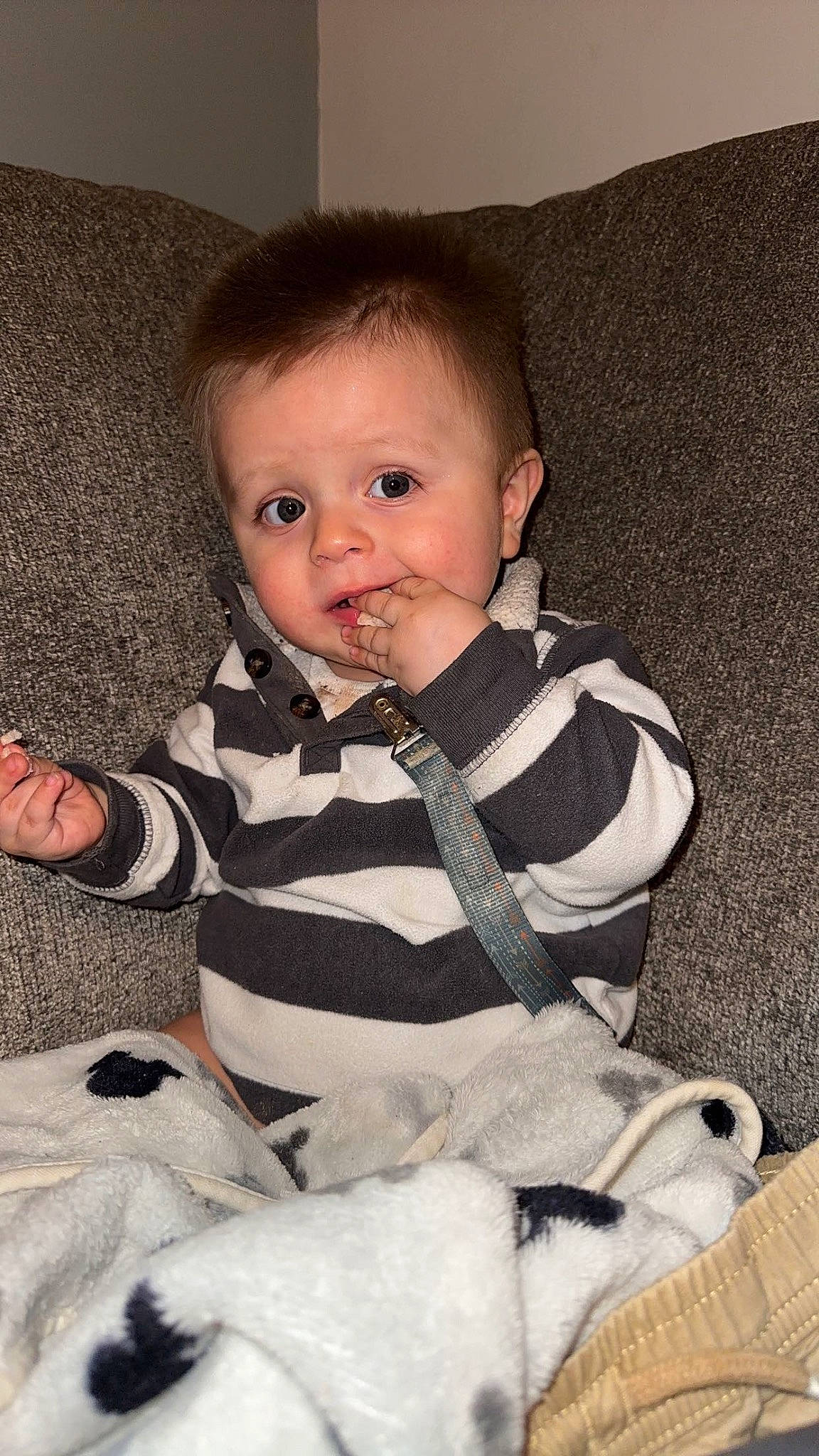 Iker is registered to the contest to win money with this photo: baby, baby_toddler_clothing, cheek, child, collar, comfort, eye, face, flooring, fur, head, human_body, iris, linens, pattern, person, sitting, skin, sleeve, toddler