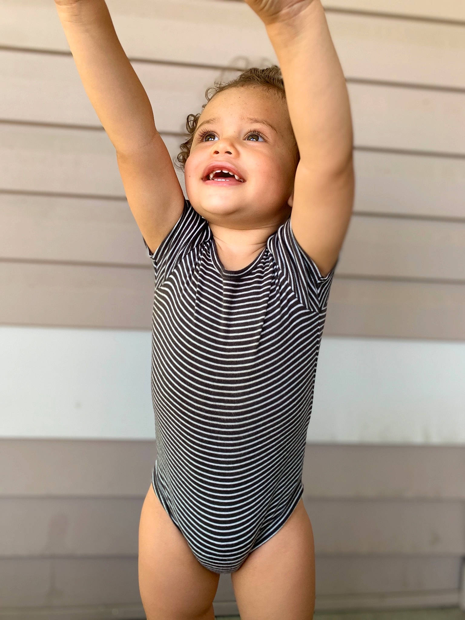 Nate is registered to the contest to win money with this photo: arm, child, child_model, clothing, joy, leotard, maillot, muscle, one_piece_swimsuit, person, smile, sportswear, swimwear, toddler