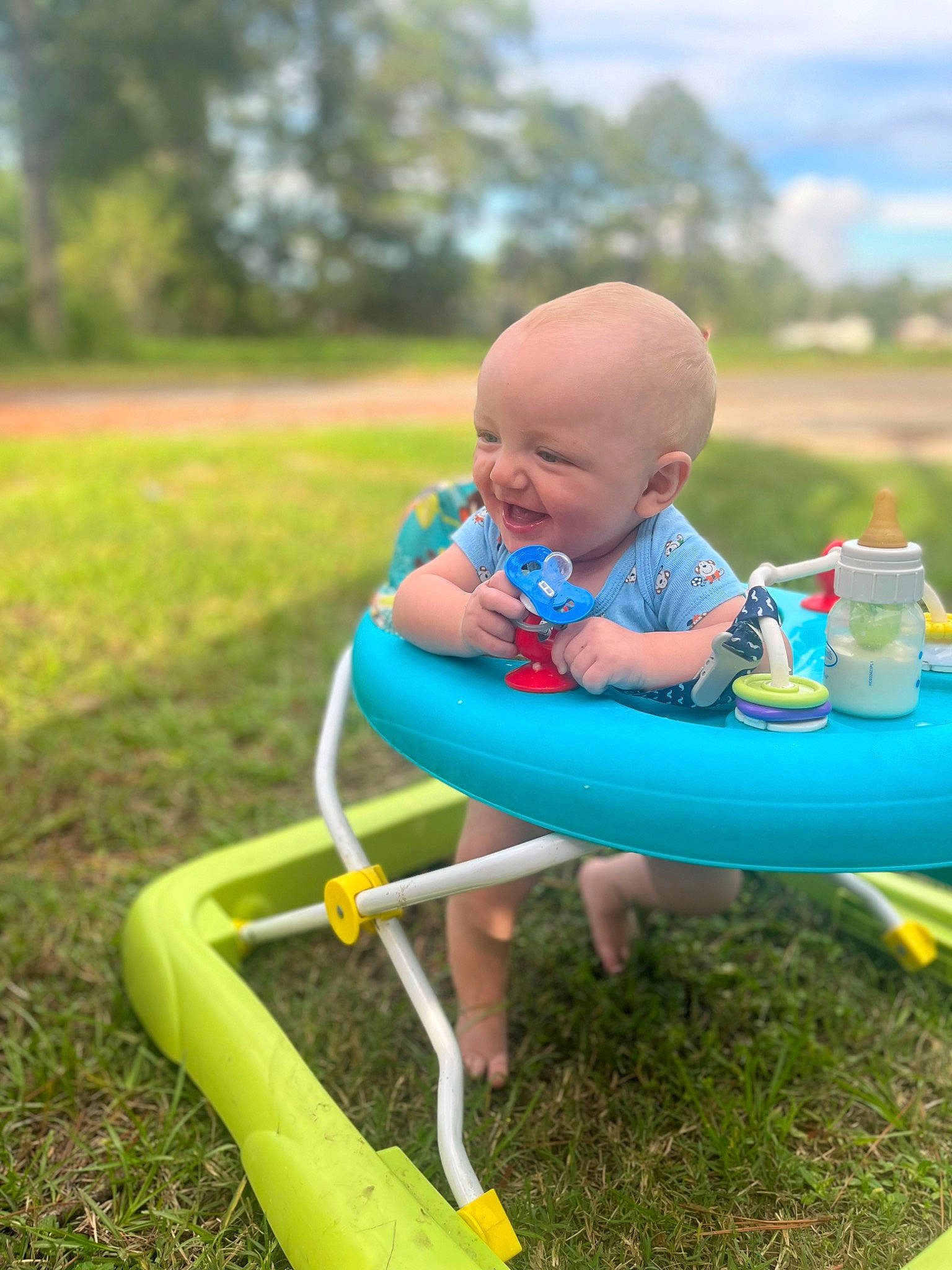 Aj is registered to the contest to win money with this photo: baby, baby_toddler_clothing, chair, cloud, electric_blue, fun, grass, happy, lawn, leisure, outdoor_furniture, people_in_nature, person, recreation, shorts, sitting, sky, toddler, tree, water_bottle
