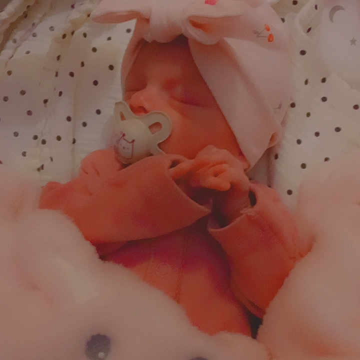 Ebonnie-Leigh is registered to the contest to win money with this photo: baby, bed, blanket, child, cozy, cute, cute_outfit, face, hand, headband, heart_emoji, indoors, infant, newborn, pacifier, pink, plush_toy, rest, sleeping, soft