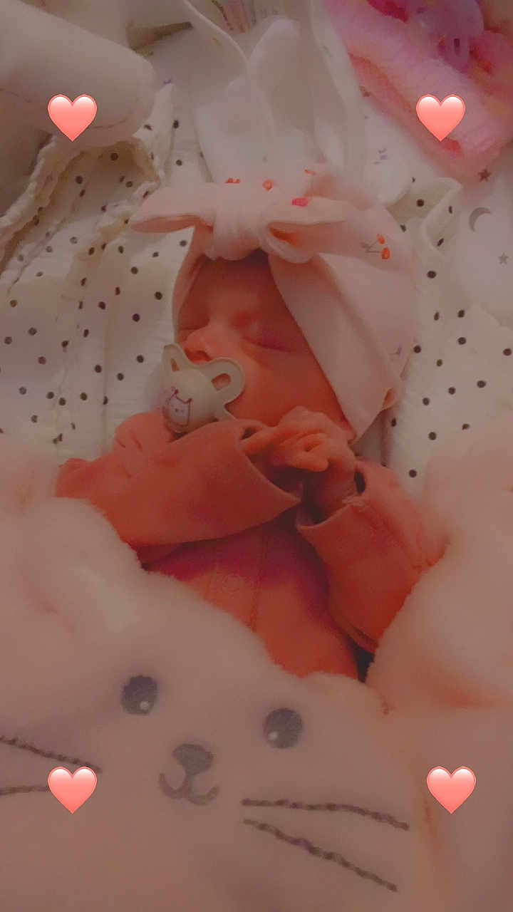 Ebonnie-Leigh is registered to the contest to win money with this photo: baby, newborn, sleeping, pink, blanket, headband, pacifier, plush_toy, heart_emoji, cozy, infant, cute, soft, bed, child, face, hand, cute_outfit, rest, indoors