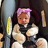 Ayannah is registered to the contest to win money with this photo: baby, car_seat, infant, headband, pink_bow, mittens, safety_harness, curious_expression, child, seatbelt, indoor, newborn, clothing, person, cute, portrait, child_seat, baby_clothes, seat, strapped_in