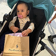 Mila Vardanyan joined the competition — help win amazing prizes! baby, black_stroller, casual, child, clothing, daytime, footwear, hand, infant, outdoor, pacifier, people, person, polo_ralph_lauren, retail, shopping_bag, sidewalk, stroller, sunlight, urban