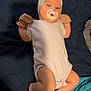 baby, infant, pacifier, headband, bow, onesie, mittens, barefoot, lying_down, bed, blanket, blue_blanket, skin, cute, newborn, child, sleepy, resting, indoors, person