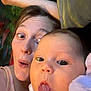 Nellie is registered to the contest to win money with this photo: baby, adult, face, tongue, expression, funny_face, selfie, indoor, person, child, blanket, clothing, soft_toy, head, skin, eyes, mouth, happy, cute, cozy