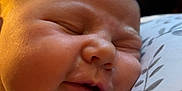 Nellie joined the competition — help win amazing prizes! baby, sleeping, close_up, face, infant, pillow, pattern, peaceful, resting, skin, head, hand, indoors, soft_light, newborn, cute, portrait, child, cozy, warm