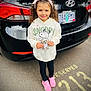 bumper, car, child, clothing, face, female, footwear, girl, head, licenseplate, longsleeve, pants, person, photography, portrait, sedan, shoe, sleeve, transportation, vehicle