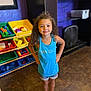child, clothing, computerhardware, curlyhair, electronics, face, female, footwear, girl, hair, hardware, head, indoors, monitor, person, photography, portrait, screen, shoe, shorts