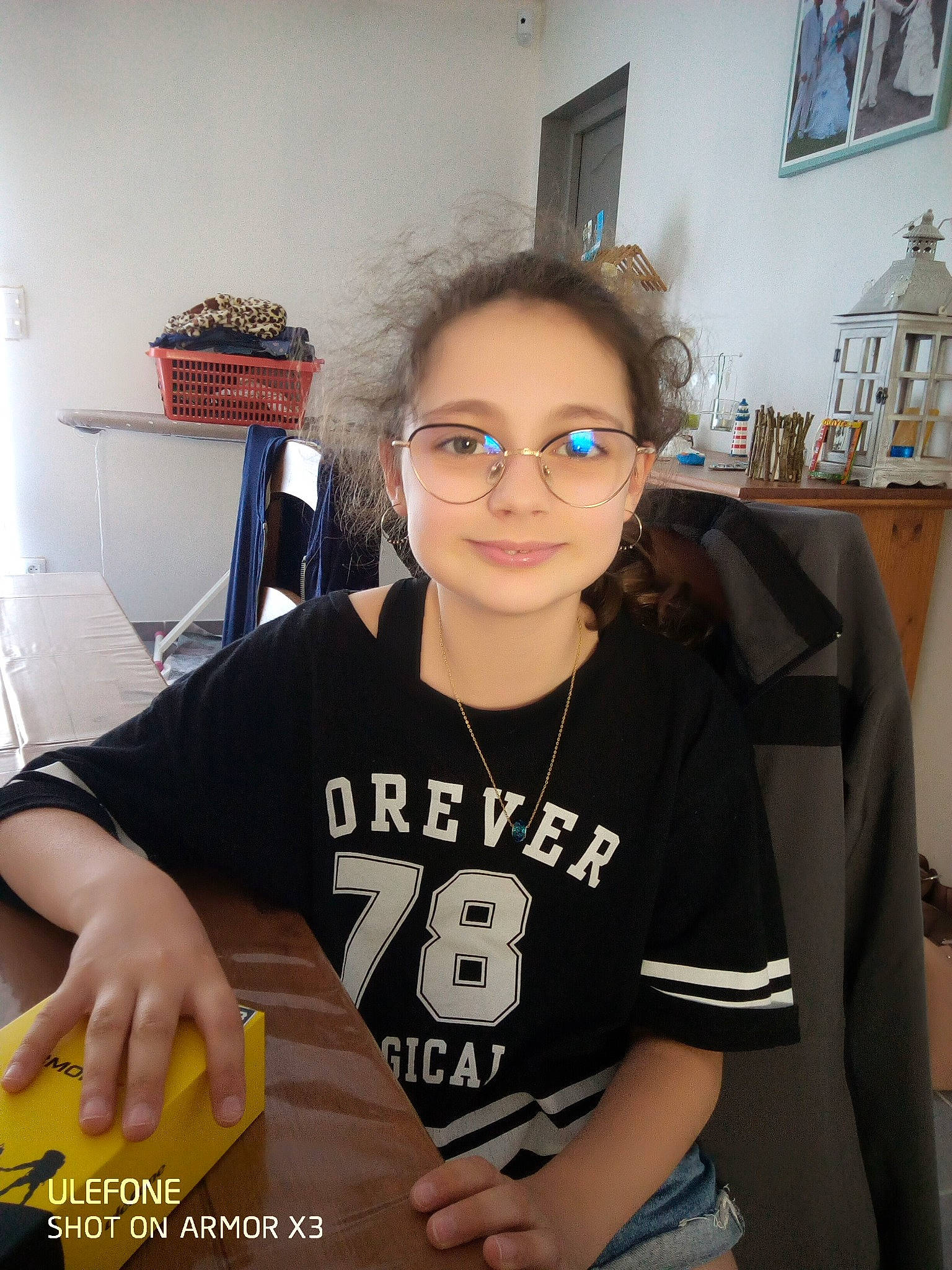 Aurlyne participe au concours pour gagner de l'argent avec cette photo : brown_hair, chair, event, eyewear, fashion_design, flooring, fun, glasses, happy, joy, long_hair, person, picture_frame, shoulder, sitting, sleeve, smile, sportswear, standing, t_shirt