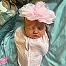 baby, newborn, swaddled, blanket, pink_flower, headband, sleeping, pacifier, blue_fabric, infant, cute, child, peaceful, soft, portrait, clothing, closeup, resting, indoors, face