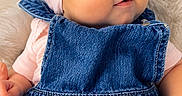 Elyanna is registered to the contest to win money with this photo: baby, child, infant, portrait, smiling, blue_eyes, pink_bow, headband, denim, overalls, pink_shirt, fluffy_blanket, indoor, close_up, sitting, fashion, cute, happy, face, photography