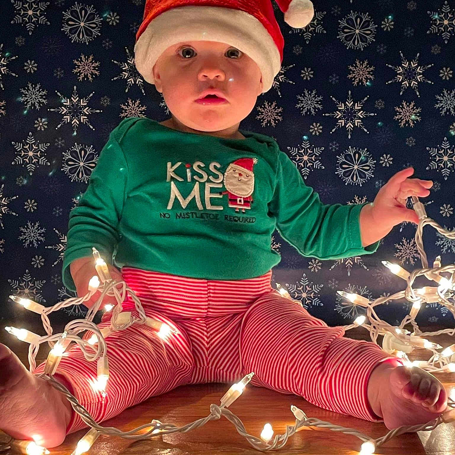 Madilyn is registered to the contest to win money with this photo: baby, baby_toddler_clothing, cap, child, christmas, christmas_decoration, christmas_eve, christmas_ornament, costume_hat, event, fictional_character, happy, holiday, holiday_ornament, magenta, ornament, pattern, santa_claus, sleeve, toddler