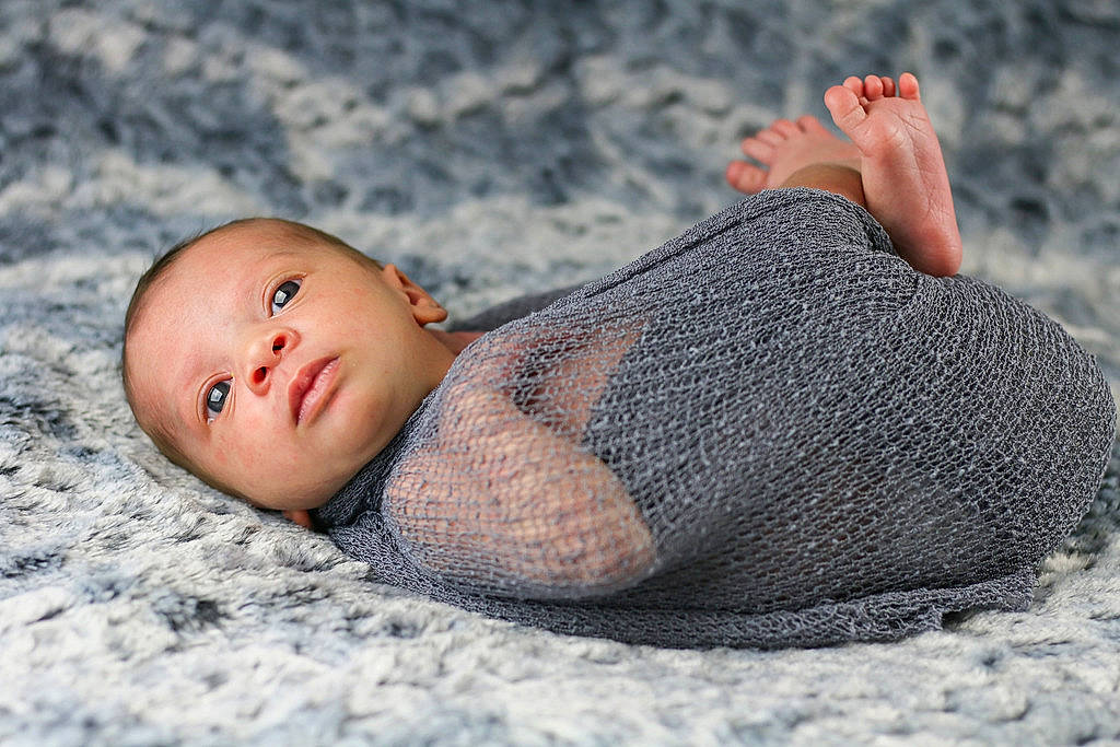 Aurora is registered to the contest to win money with this photo: baby, barefoot, beach, child, comfort, foot, fur, grass, grey, hand, human_body, human_leg, leg, linens, pattern, person, sand, sitting, toddler, wood
