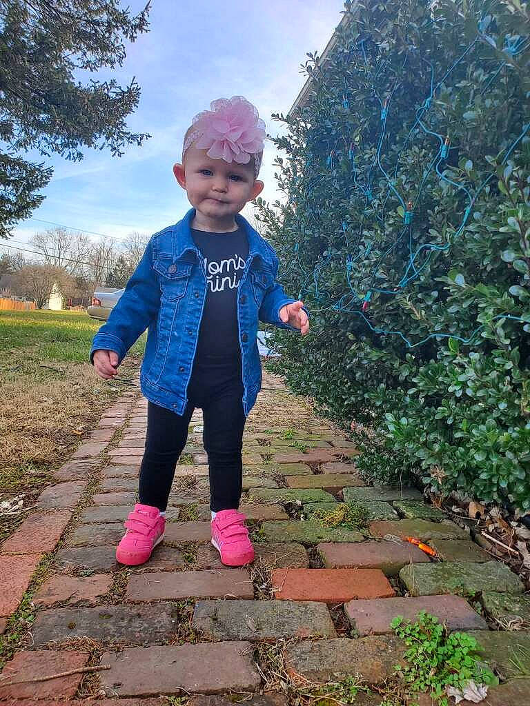 Layla is registered to the contest to win money with this photo: child, cloud, electric_blue, fun, grass, grassland, happy, headwear, landscape, leisure, magenta, pattern, people_in_nature, person, plant, recreation, road_surface, sky, soil, standing
