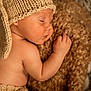 baby, sleeping, knitted_hat, knitted_pants, blanket, cozy, soft_texture, infant, close_up, cute, peaceful, child, skin, newborn, resting, warm, indoors, portrait, cuteness, toddler